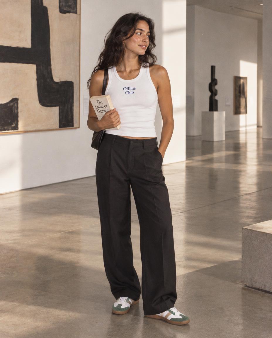 Woman in the Offline Club rib tank holding a book